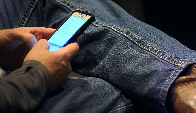 Man on phone looking at social media