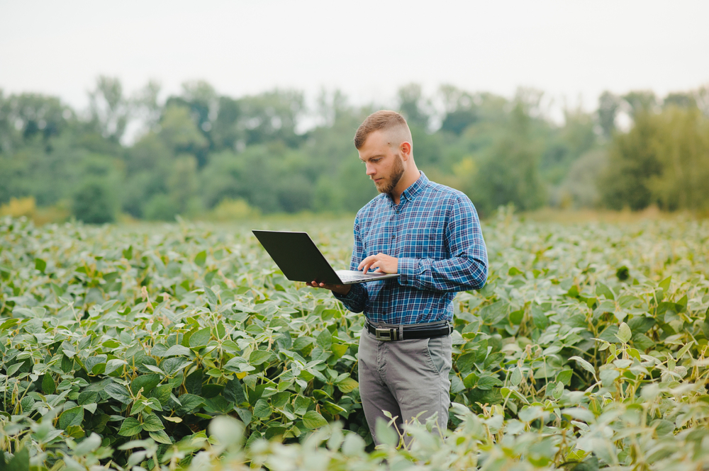 Man in field with computer